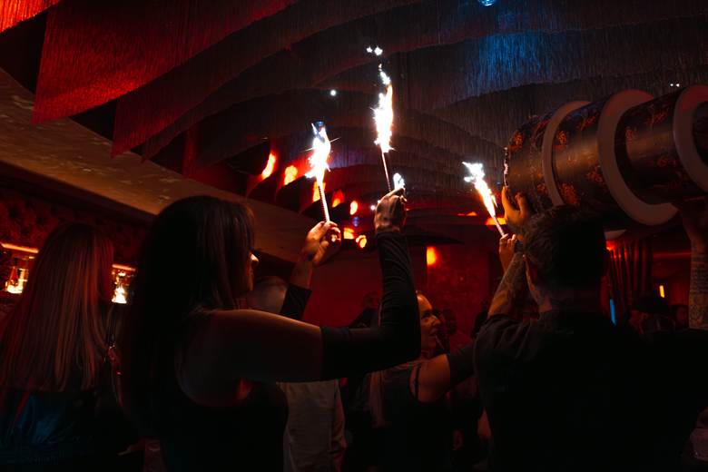 A woman celebrating at ZuZu in Detroit.